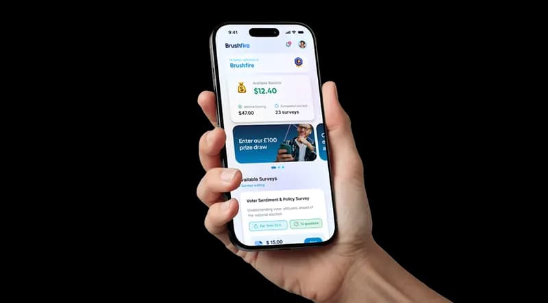 Hand holding a phone showing the Brushfire app